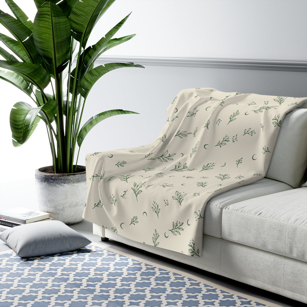 Cream Sage sherpa blanket draped over a sofa