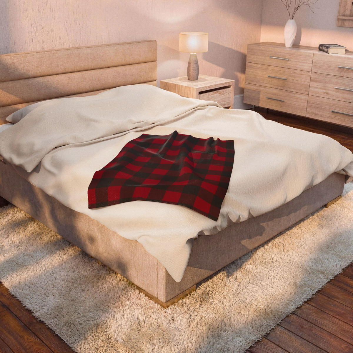Cranberry Buffalo Check plush blanket on a bed beside a bedside lamp