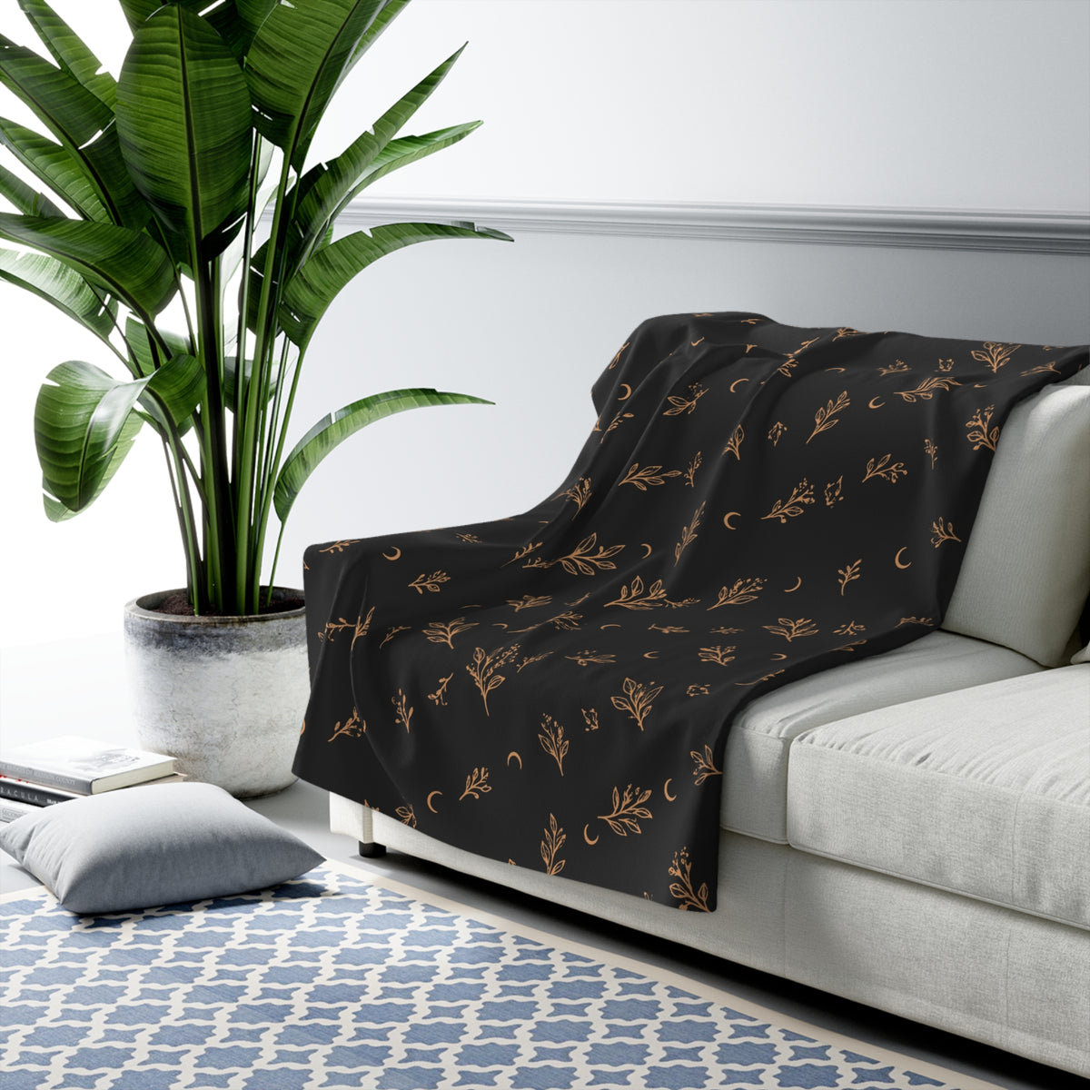 Charcoal Copper sherpa blanket draped over a sofa
