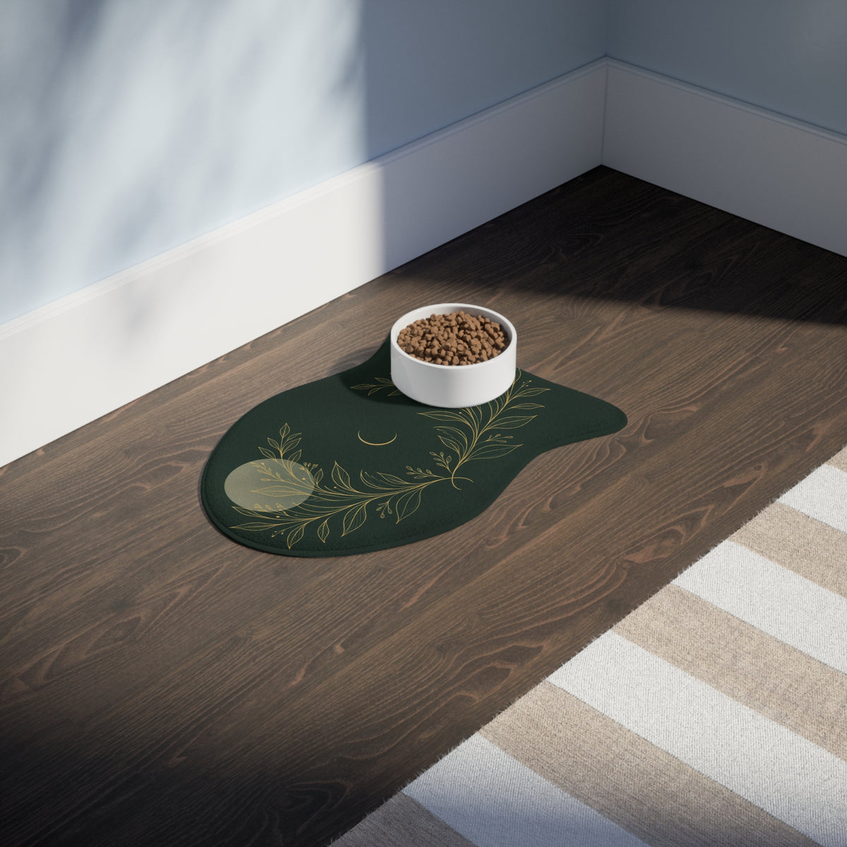 Botanical Gold fish-shaped feeding mat with a food bowl on a wooden floor