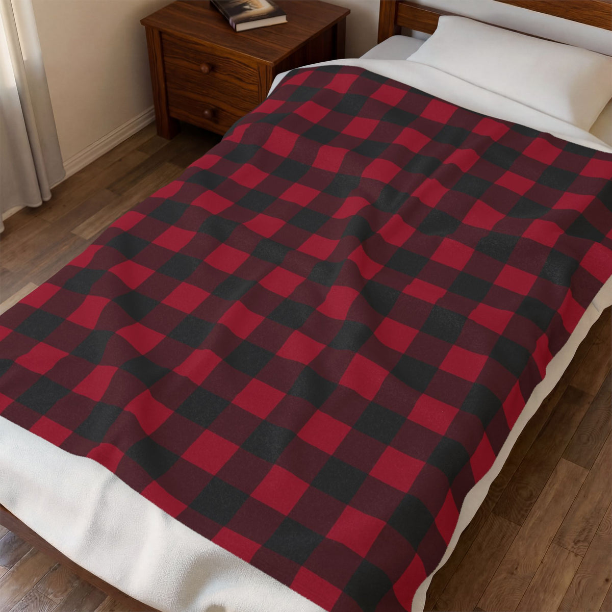 Cranberry Buffalo Check plush blanket spread across a bed