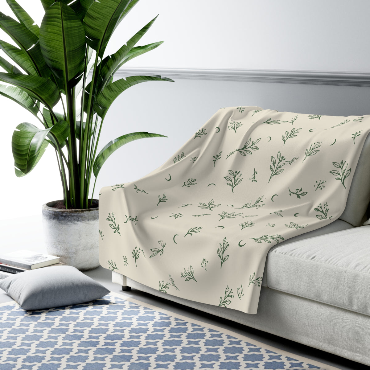 Cream Sage sherpa blanket draped over a sofa (larger size)