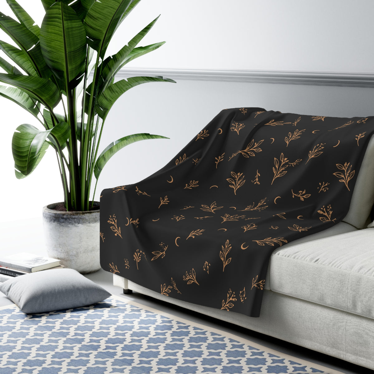 Charcoal Copper sherpa blanket draped over a sofa (larger size)
