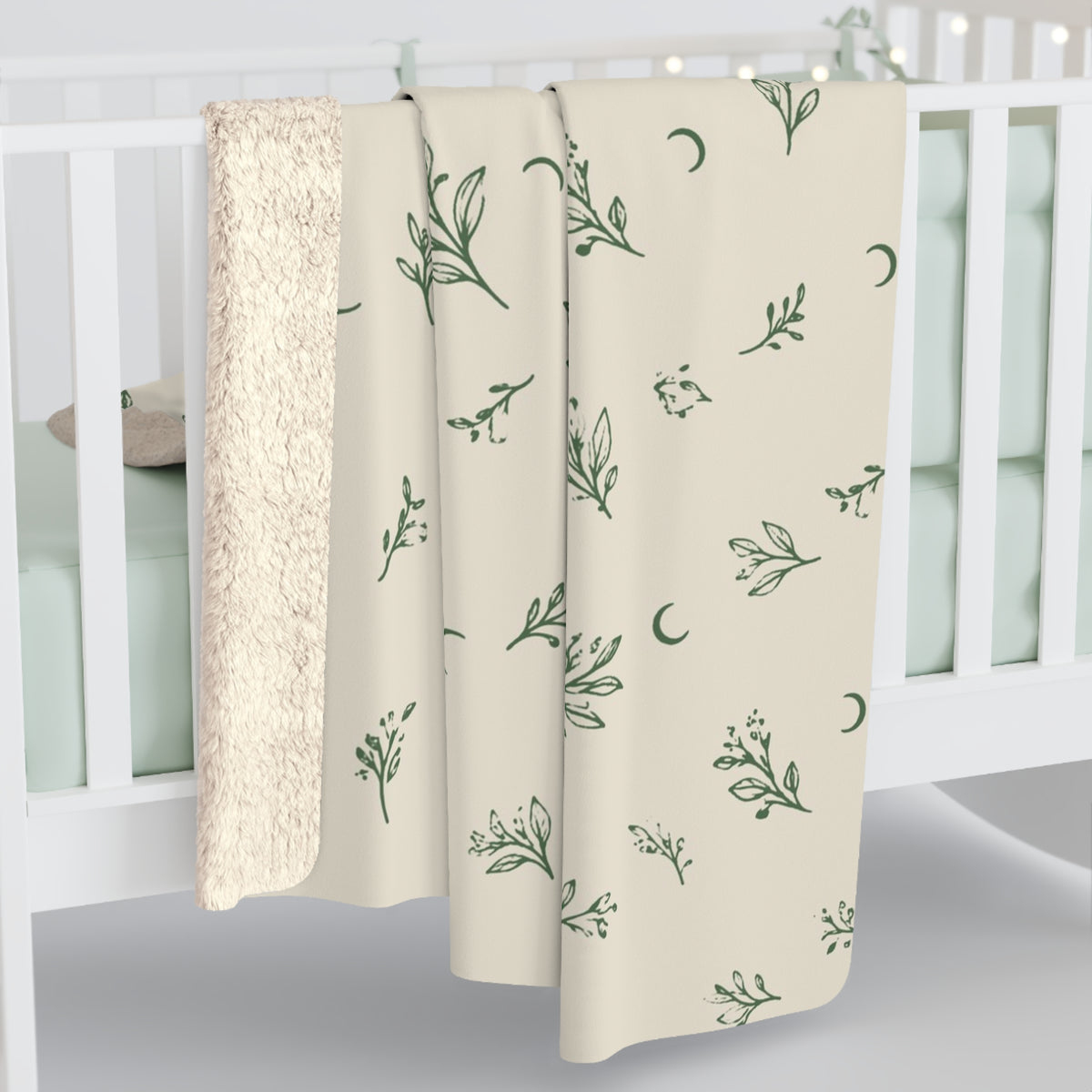Cream Sage sherpa blanket hanging over a crib rail, cream sherpa back showing (larger size)