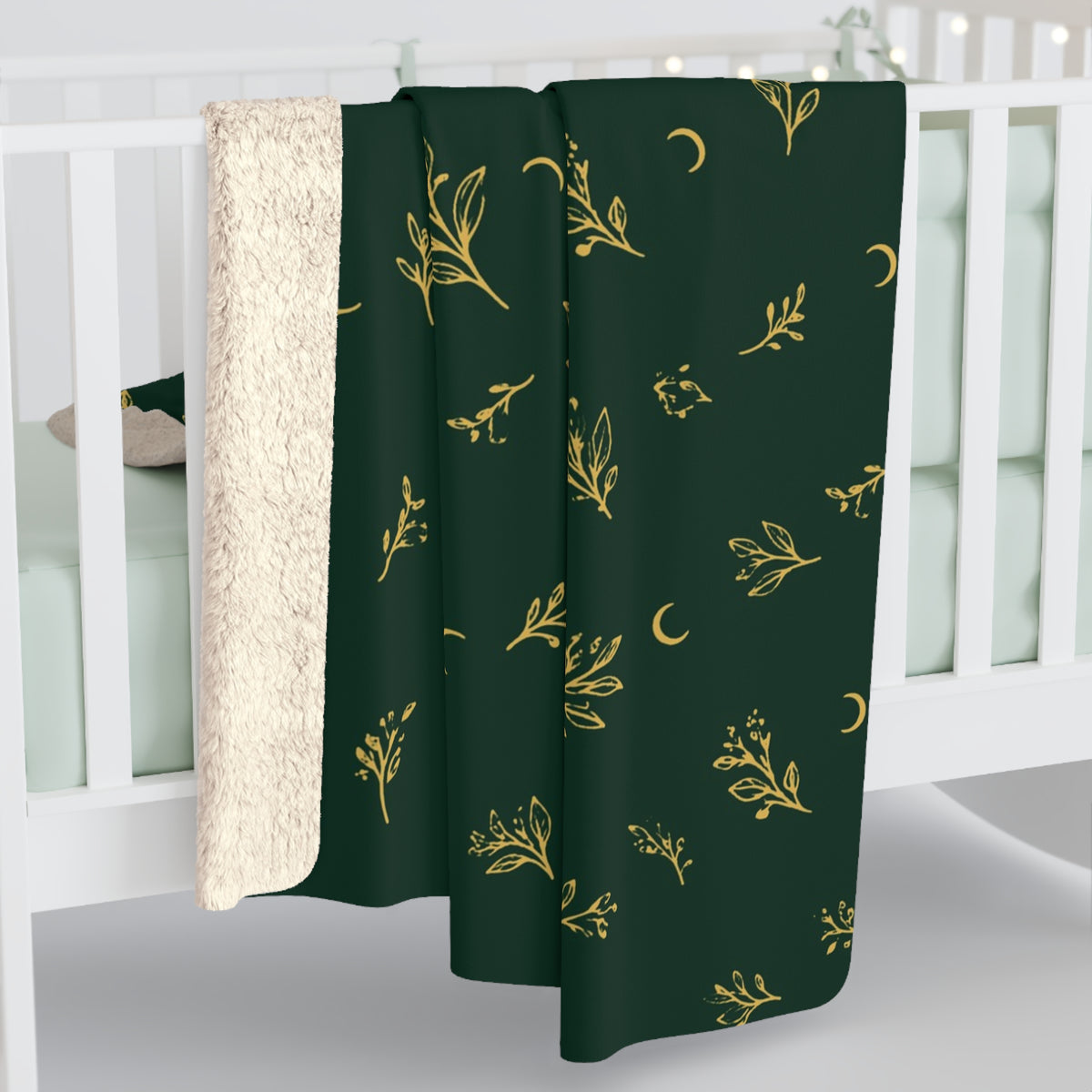 Botanical Gold sherpa blanket hanging over a crib rail (larger size)
