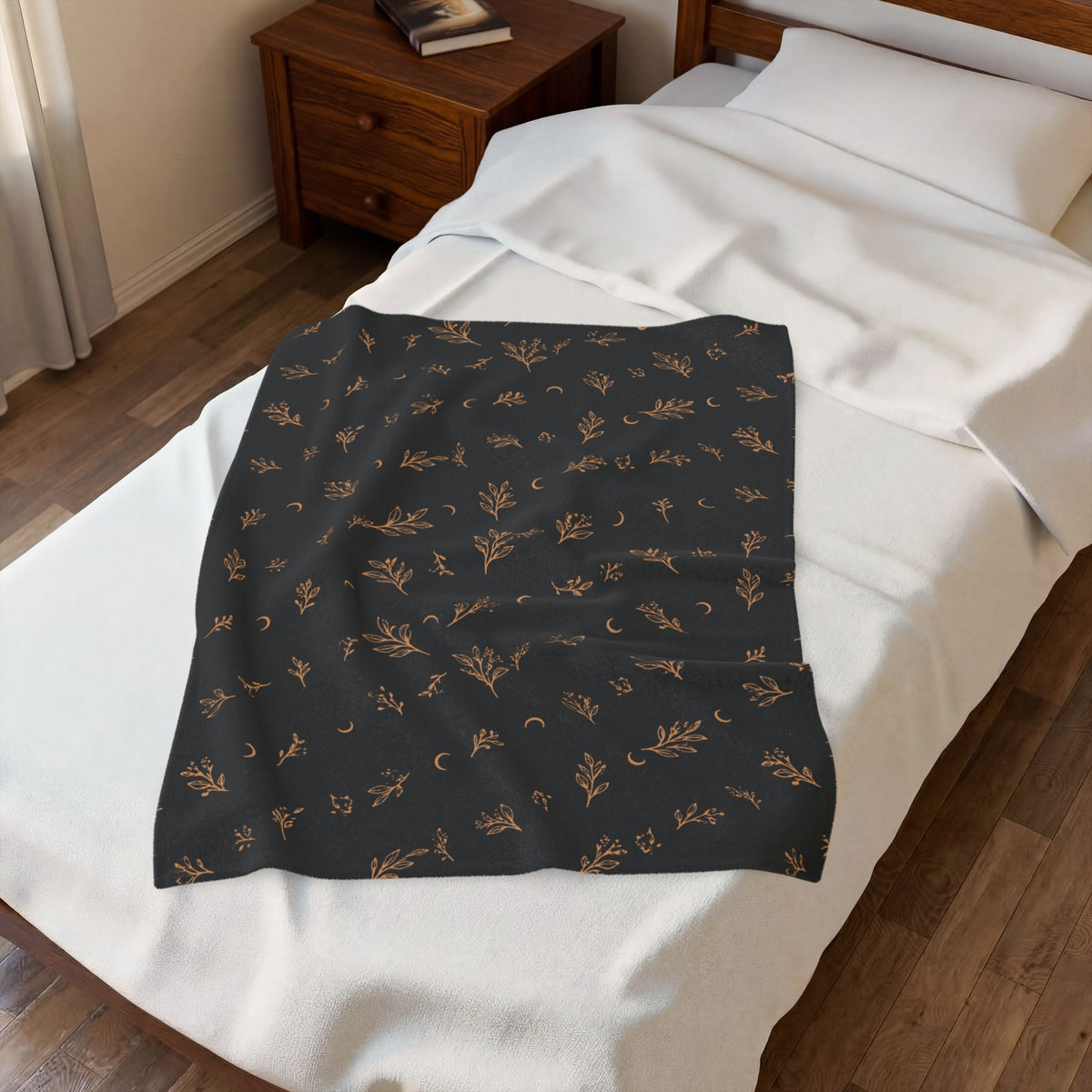 Charcoal Copper plush blanket laid on a white bed, seen from above