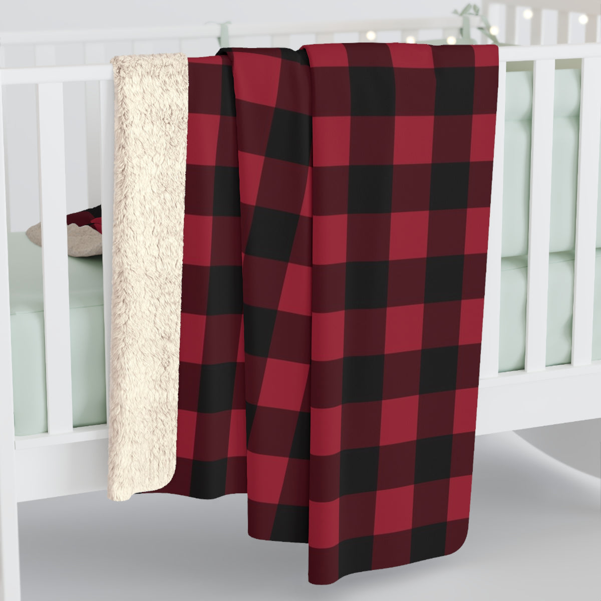 Cranberry Buffalo Check sherpa blanket hanging over a crib rail, cream sherpa back showing (larger size)