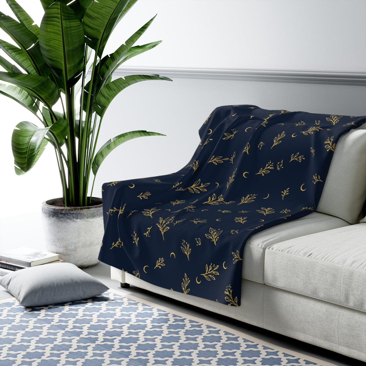 Navy Gold sherpa blanket draped over a sofa