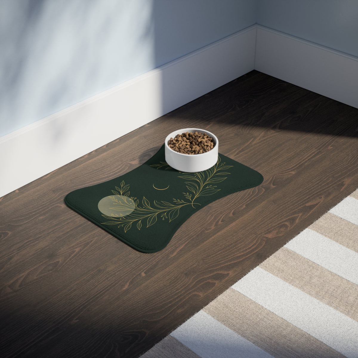 Botanical Gold bone-shaped feeding mat with a food bowl on a wooden floor