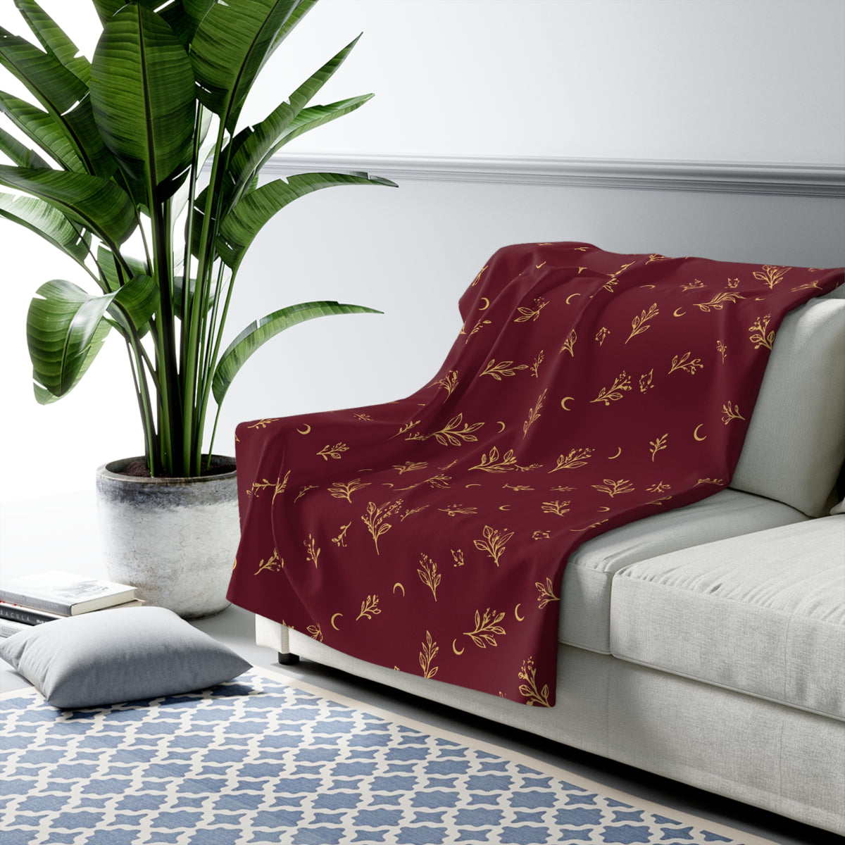Cranberry Gold sherpa blanket draped over a sofa