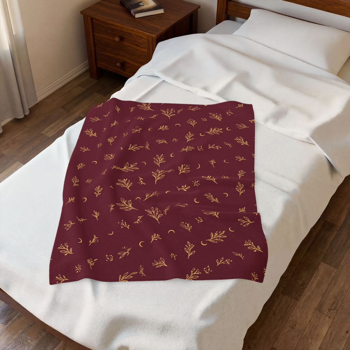 Cranberry Gold plush blanket laid on a white bed, seen from above