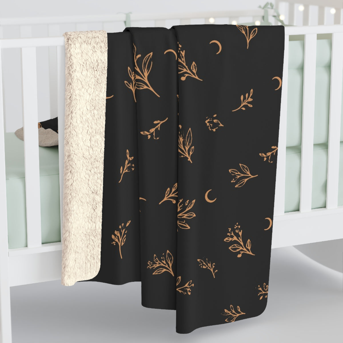 Charcoal Copper sherpa blanket hanging over a crib rail, cream sherpa back showing (larger size)
