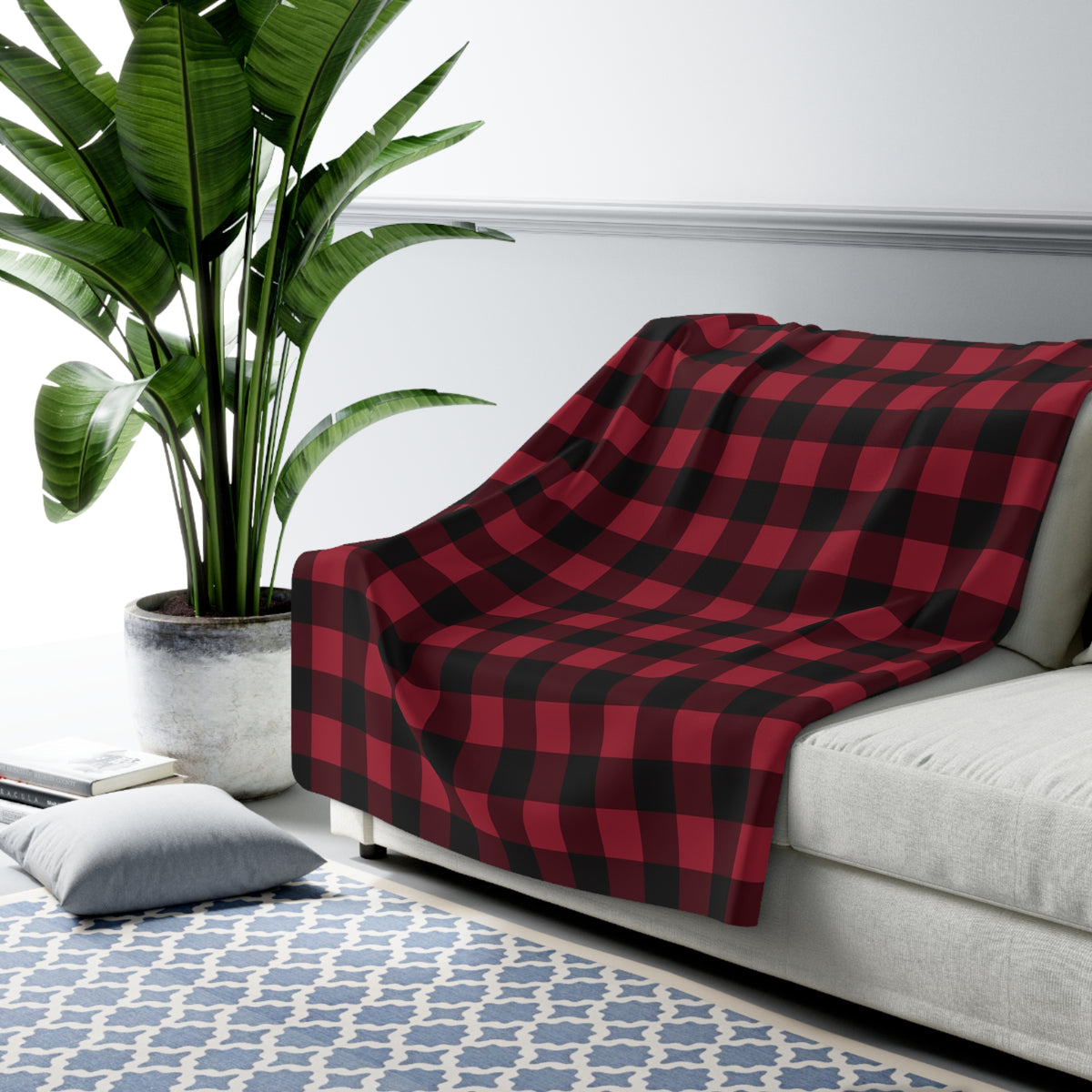 Cranberry Buffalo Check sherpa blanket draped over a sofa (larger size)